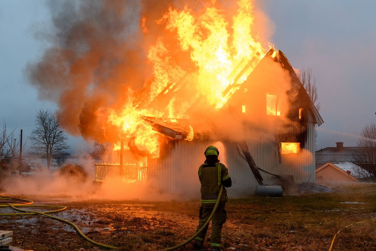 Norwegian,Firefighter,Trying,To,Put,Out,Flames,House,On,Fire