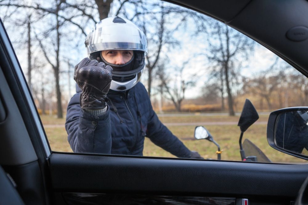 Angry,Motorcyclist,Knocking,With,Fist,In,Leather,Glove,In,Car
