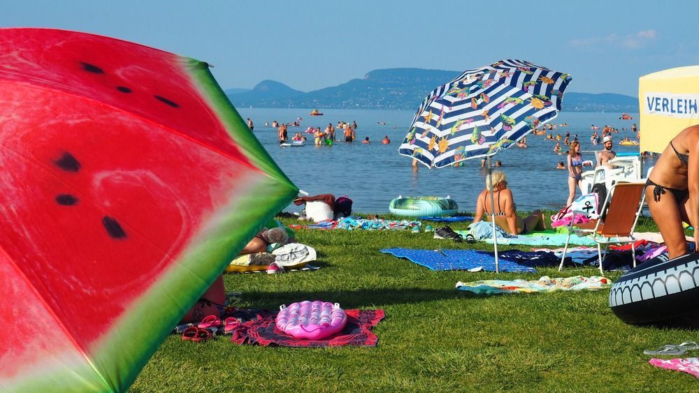 Balatonmáriafürd?,,Hungary,-,July,29,,2020:,Colorful,Umbrellas,,Sunbathing,And